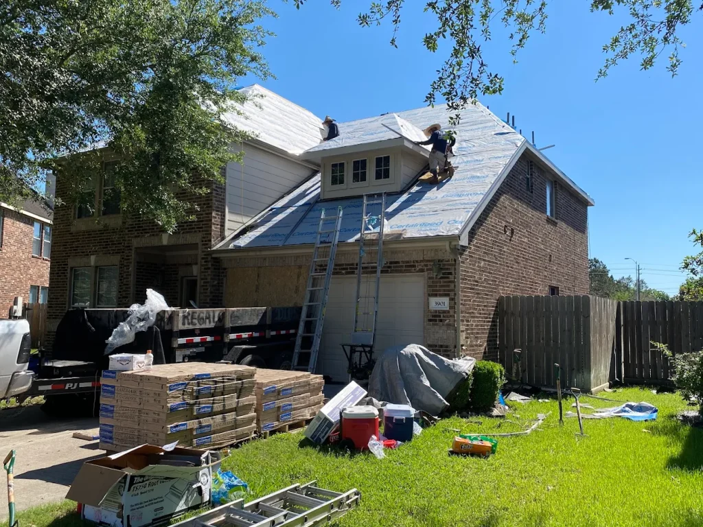 Roofing installation: Integrity storm experts team installing asphalt